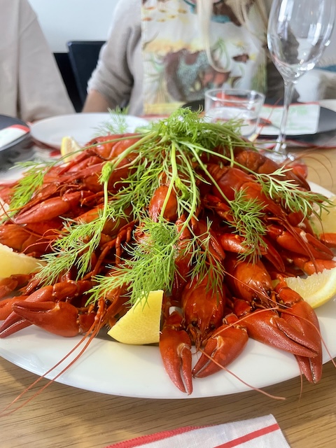 Lautasella keko rapuja, tilliä ja sitruunaveneitä.